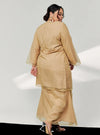 A woman in dressed in Sand Tun Sharimah Organza Kurung