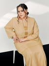A woman in dressed in Sand Tun Sharimah Organza Kurung