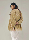 A woman dressed in Sand Tun Ava Peplum Embroidered Top