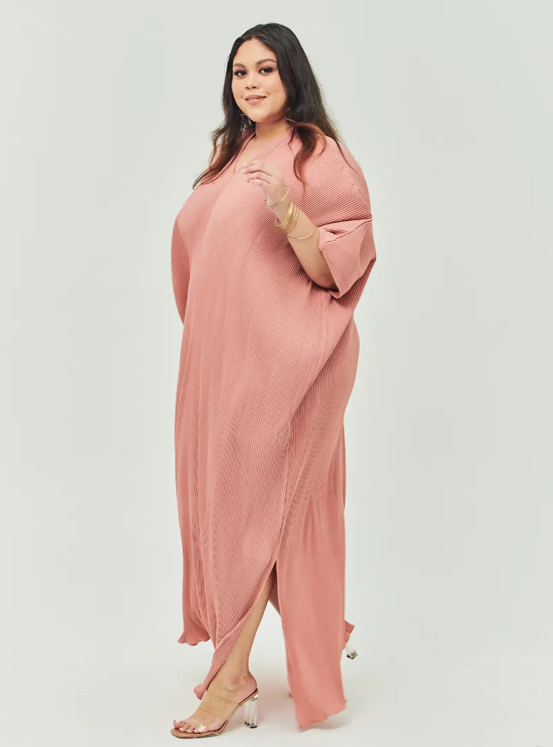 A woman Dressed in Baby Salmon Signature Pleated Kaftan