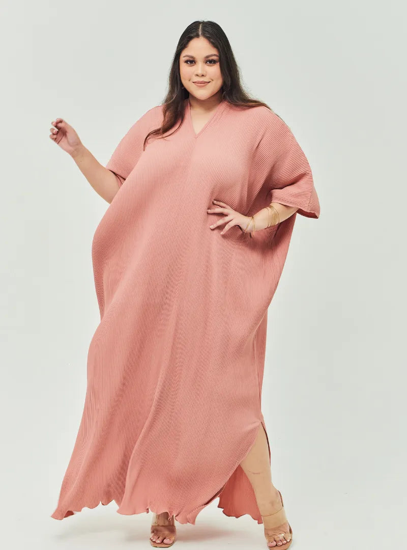 A woman Dressed in Baby Salmon Signature Pleated Kaftan