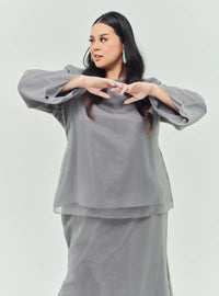 A woman dressed in Silver Grey Tun Aminah Organza Basic Kurung