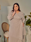 A woman dressed in Silver Grey Tun Tipah Dotted Wrap Kurung