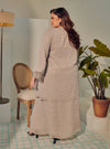 A woman dressed in Silver Grey Tun Tipah Dotted Wrap Kurung