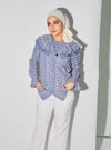 A woman dressed in Stone Blue Maisara Eyelet Ruffles Top