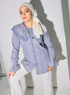 A woman dressed in Stone Blue Maisara Eyelet Ruffles Top