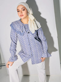 A woman dressed in Stone Blue Maisara Eyelet Ruffles Top