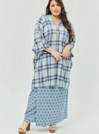 A woman dressed in Stone Blue Tun Azeeza Kaftan Top