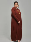 A woman dressed in Walnut Tun Aimellia Pleated Maxi Dress