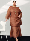 A woman in dressed in Walnut Tun Sharimah Organza Kurung