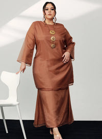 A woman in dressed in Walnut Tun Sharimah Organza Kurung