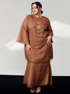 A woman in dressed in Walnut Tun Sharimah Organza Kurung