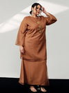 A woman in dressed in Walnut Tun Sharimah Organza Kurung