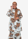 A woman dressed in White Aneesa Flower Printed Kurung