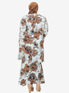 A woman dressed in White Aneesa Flower Printed Kurung
