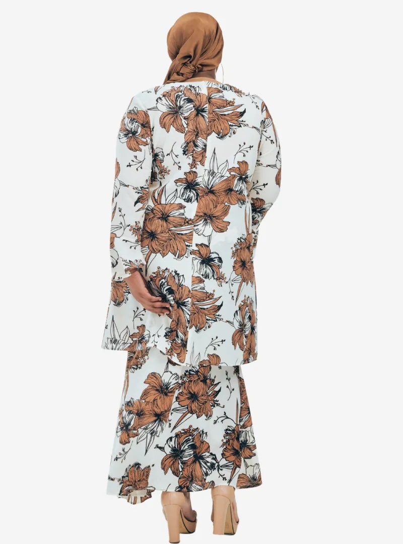 A woman dressed in White Aneesa Flower Printed Kurung