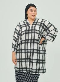 A woman dressed in White Tanah Tun Azeeza Kaftan Top